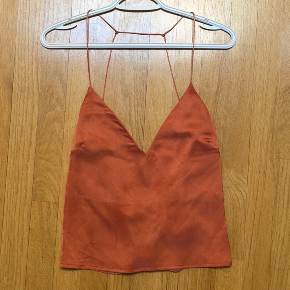Orange silky top.